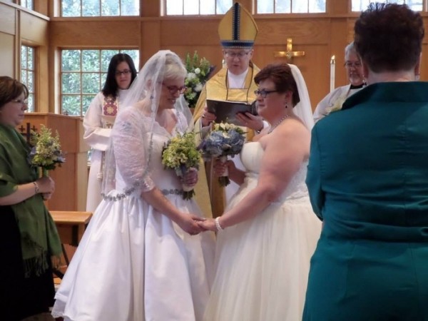 Virginia Bishop Shannon Johnston (center) presides over a same-sex blessing ceremony in November for Leslie Hague (Left) and Katie Casteel (Right).