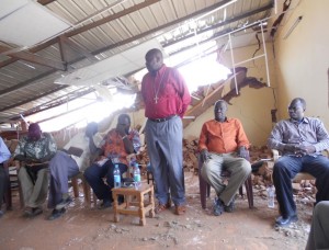 Then Bishop of Khartoum, Ezekiel Kondo, comforts the pastors after the Khartoum government bulldozed their church. (Photo credit: Free South Sudan Media Center)