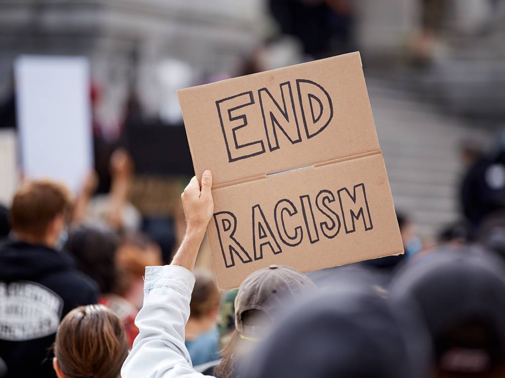 Anti-racism rally sign. Sadly, liberal bureaucratic United Methodist anti-racism efforts have needlessly chosen to undermine their own effectiveness. (Photo credit: United Methodist News Service)