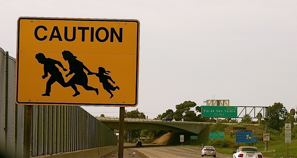 Immigrant Crossing Road Sign