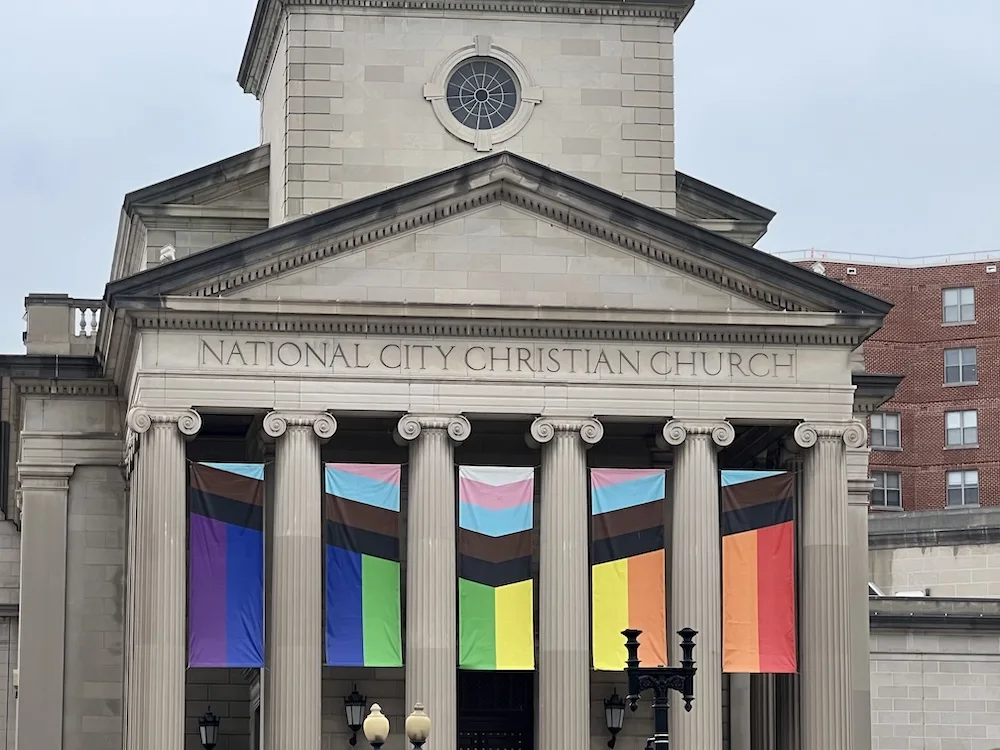 Rainbow banners adorn the columns of the neoclassical National City Christian Church.