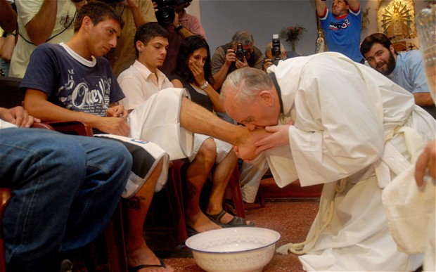 On Holy Thursday 2013, Pope Francis broke with centuries of tradition by washing the feet of the poor outside the walls of the Vatican, and by washing the feet of several juvenile inmates who were not Christian, one of whom was a Muslim girl. She appears visibly touched by the gesture in this photo.