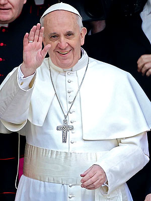 Pope Francis smiling as he waves to onlookers.